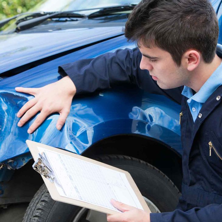 Man With Clipboard Inspecting Broken Fender 