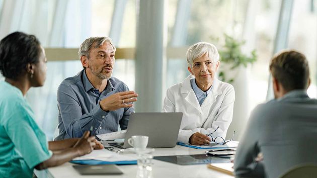 Medical Professionals Meeting Around Table 