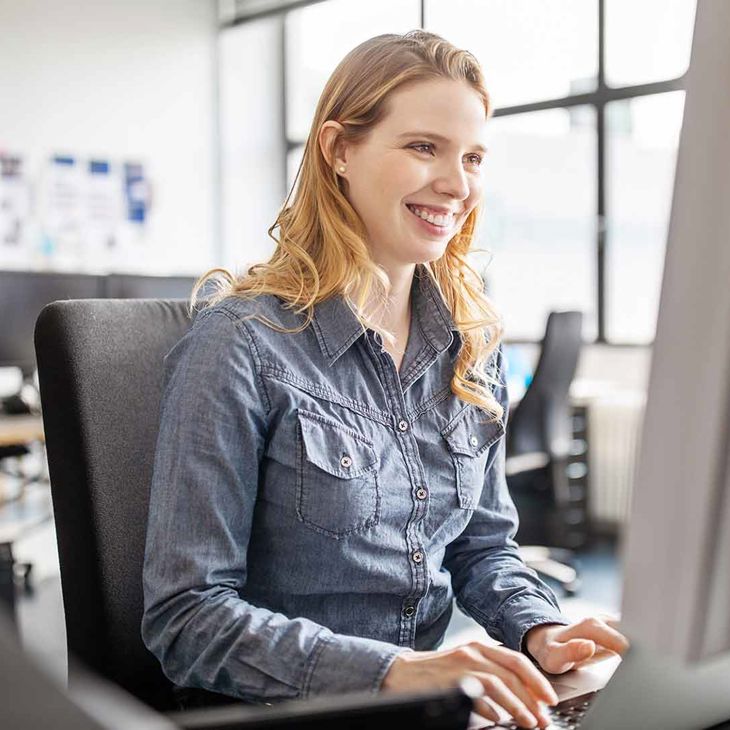 Smiling Woman Typing On Keyboard 