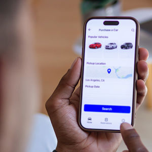 Person Holding Phone With Car Data 