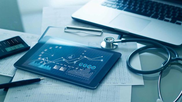 Tablet And Laptop On Table With Stethoscope 