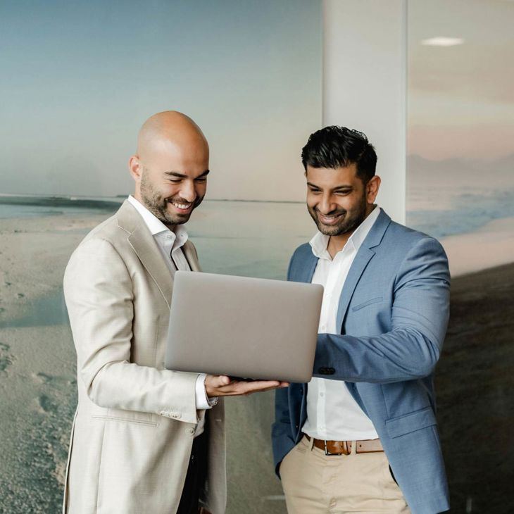 Two Men Reviewing Laptop 