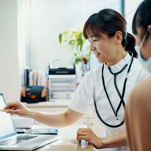 Doctor Consulting With Patient At Hospital 