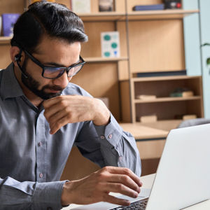 Office Working Concentrating On Laptop Screen 